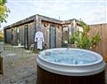 Relax in your Hot Tub with a glass of wine at Cedar Lodge, Strawberryfield Park; Cheddar; Somerset
