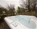 Relax in your Hot Tub with a glass of wine at Lily Pad Cottage, Trevorrick Farm; Padstow; Cornwall