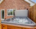 Relax in your Hot Tub with a glass of wine at Alder Lodge; Norfolk