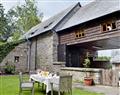 Relax in your Hot Tub with a glass of wine at Bailey Cottage; Powys