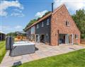 Relax in your Hot Tub with a glass of wine at Beech Farm Barns - Alderfen Barn; Norfolk