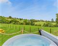 Relax in your Hot Tub with a glass of wine at Brook Valley Glamping-Oak; Powys