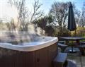 Lay in a Hot Tub at Cairnty Lodges - Red Squirrel Log Cabin; Banffshire