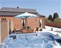 Relax in your Hot Tub with a glass of wine at Castle Farm Cottages - Woodpecker; Shropshire