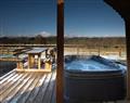 Relax in your Hot Tub with a glass of wine at Cwmllwyd Getaways - Cerniog Cabin; Powys