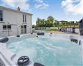 Relax in your Hot Tub with a glass of wine at Gwarwrfryn; Dyfed