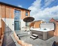 Relax in your Hot Tub with a glass of wine at Higher Hockpitt Farm - Property 1; Somerset