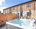 Relax in your Hot Tub with a glass of wine at Higher Hockpitt Farm - Property 2; Somerset