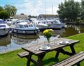 Enjoy a glass of wine at Houseboats - Ardea; Norfolk