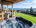 Relax in your Hot Tub with a glass of wine at Lauriston Bungalow; Devon