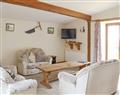 Enjoy a glass of wine at Little Clyst William Farm Cottages - Orchard View Barn; Devon