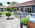 Relax in your Hot Tub with a glass of wine at Lodge Farm Barn; England
