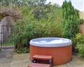 Relax in your Hot Tub with a glass of wine at Mallard Cottage; West Yorkshire