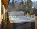 Relax in your Hot Tub with a glass of wine at Otterburn Hall Lodges - Juniper Lodge; Northumberland