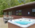 Relax in your Hot Tub with a glass of wine at Otterburn Hall Lodges - Leafy Run; Northumberland
