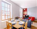 Enjoy a glass of wine at Quire Court Apartments- Apartment 11; Gloucestershire