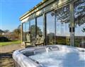 Relax in your Hot Tub with a glass of wine at Sea View Lodge; Devon