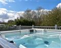 Relax in your Hot Tub with a glass of wine at The Lazy Otter Lodges - The Lazy Otter 29; Cambridgeshire