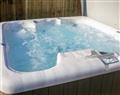 Relax in your Hot Tub with a glass of wine at The Round House; Devon