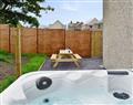 Relax in your Hot Tub with a glass of wine at Ty Traws; Gwynedd