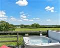 Relax in your Hot Tub with a glass of wine at Well Farm Holiday Cottages - Rivendell Glamping Pod; Cornwall
