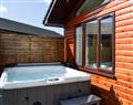 Relax in your Hot Tub with a glass of wine at Woodburn Lodges - The Spey; Lanarkshire