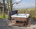 Relax in your Hot Tub with a glass of wine at Ymwlch Barns - Dutch Barn One; Gwynedd