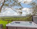 Relax in your Hot Tub with a glass of wine at Ymwlch Barns - Dutch Barn Two; Gwynedd
