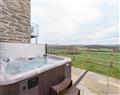 Relax in your Hot Tub with a glass of wine at Ysgubor; Denbighshire
